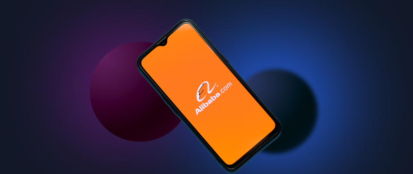 Close-up of a smartphone displaying an orange logo on its back, symbolizing Alibaba's mobile app stock shares.